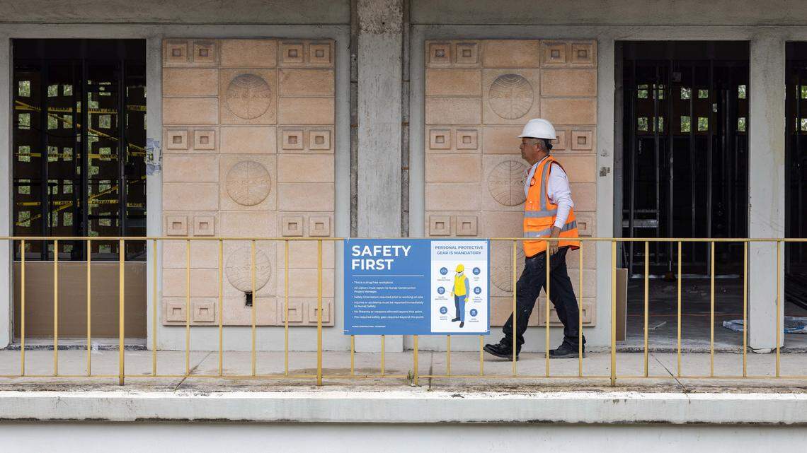 A construction worker walks through the construction area of Miami International Airport’s VIP terminal on Wednesday, July 23, 2025, in Miami, Fla.