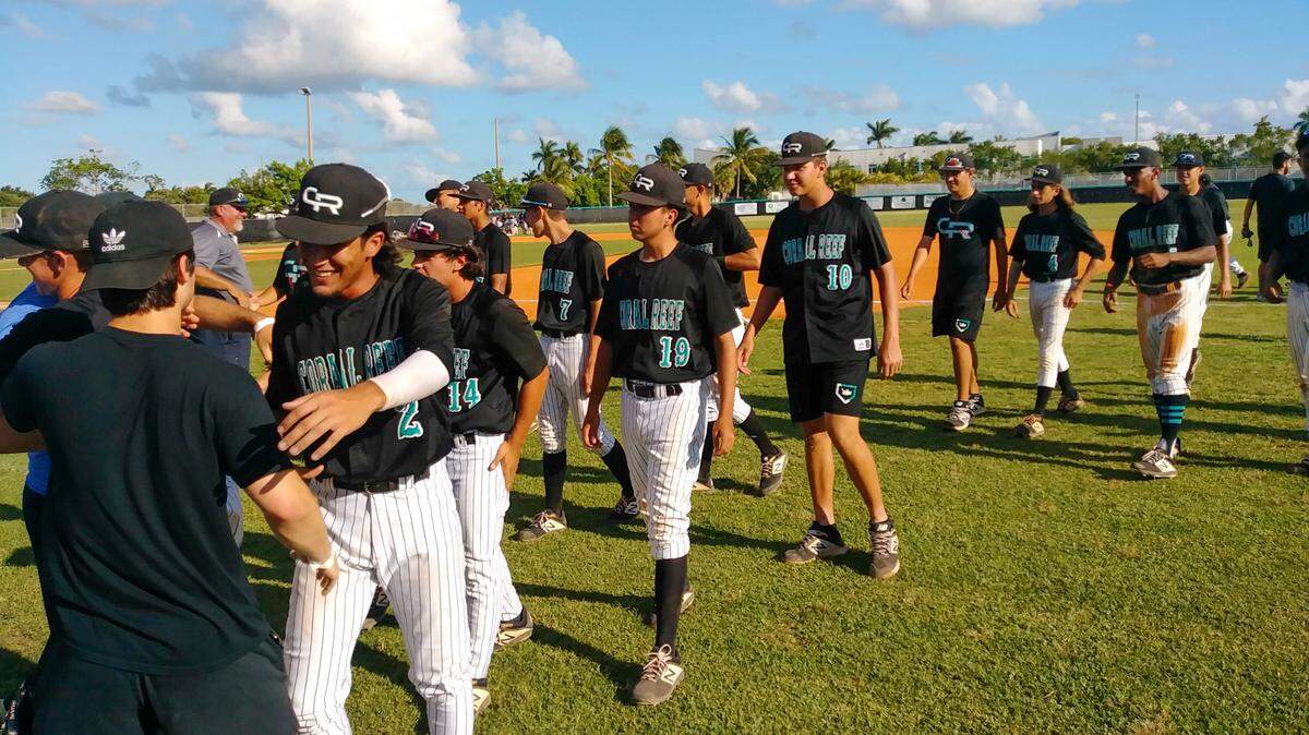 The Coral Reef baseball team celebrates after defeating Coral Park in the Region 4-9A final on Wednesday, May 22, 2019.