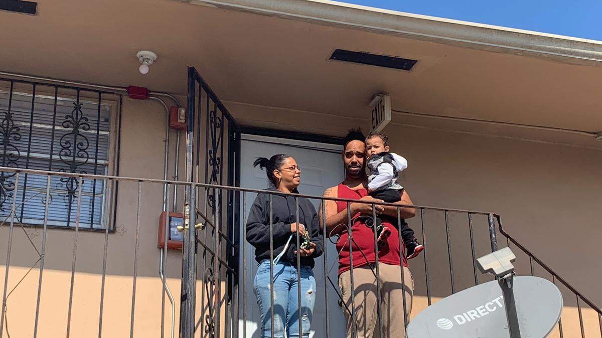 Jhama Alvarado (left), her brother Eliezer Alvarado and her one-year-old child stand outside their apartment in Opa-locka on Jan. 21. They were recently without water for several days.
