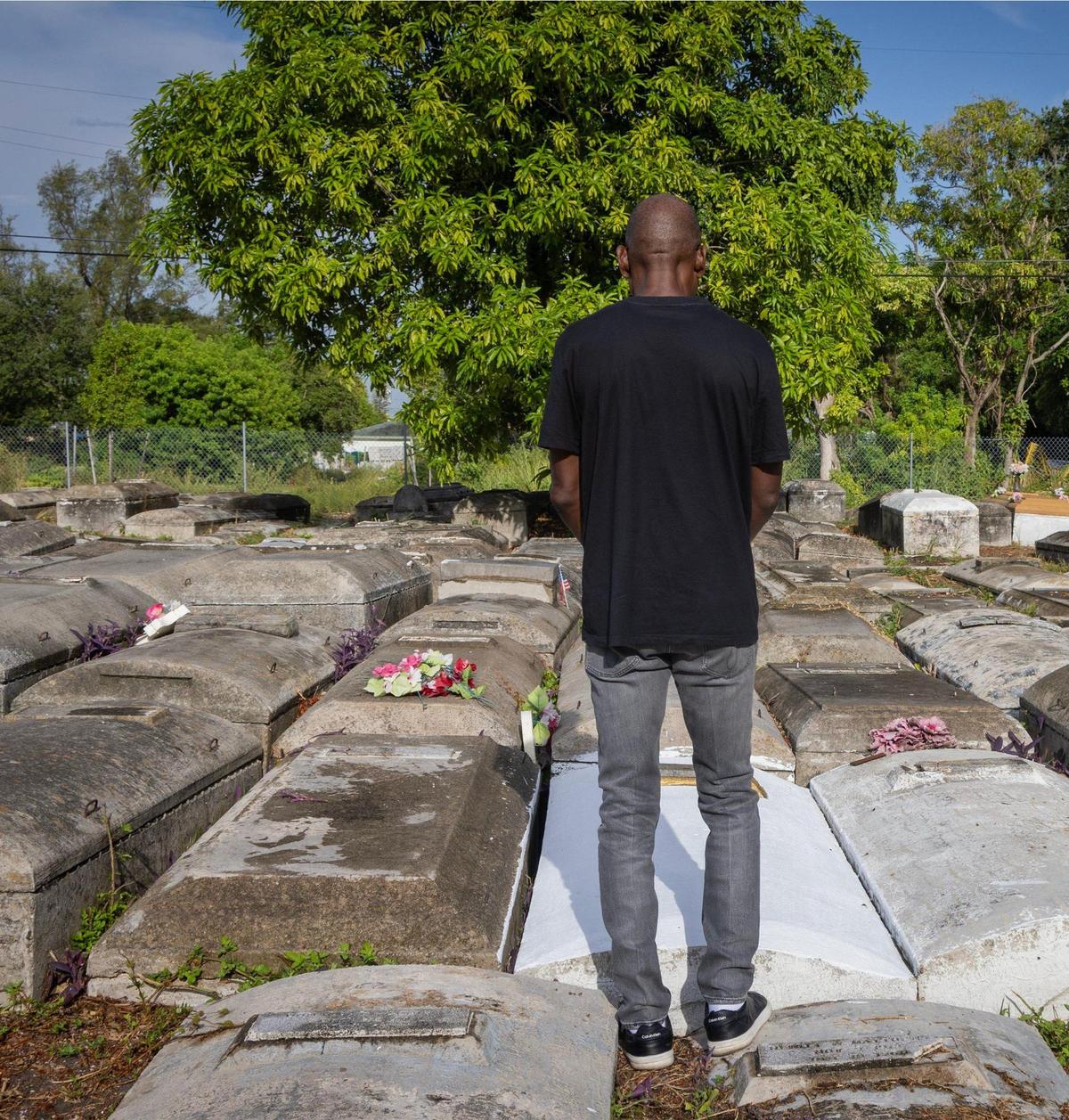 Jessie Wooden stands over his mother’s grave in prayer - a ritual practiced upon every time he comes to Lincoln Memorial Park, which he purchased after finding his mother in the neglected cemetery.
