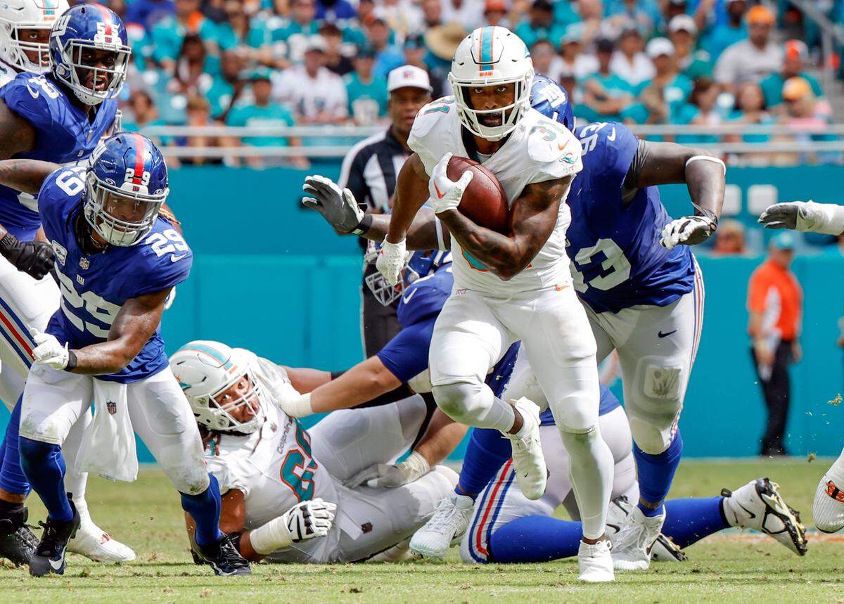 Miami Dolphins running back Raheem Mostert (31) carries for a first down in the second half against the New York Giants at Hard Rock Stadium in Miami Gardens on Sunday, October 8, 2023.