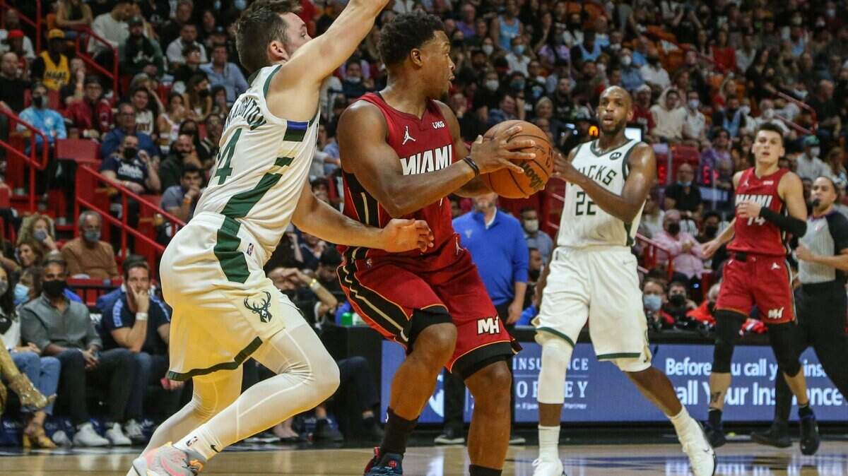 Miami Heat guard Kyle Lowry (7) twists his ankle as Milwaukee Bucks guard Pat Connaughton (24) defends during the first quarter at FTX Arena in Miami on Thursday, October 21, 2021.