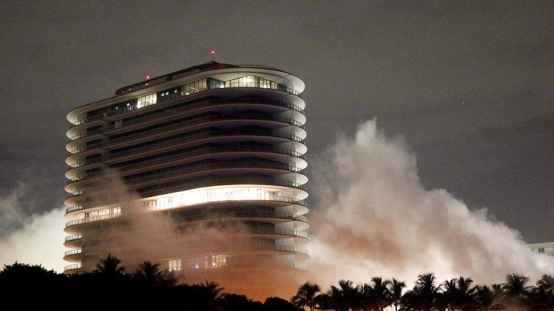 Champlain Towers South collapses near the Eighty Seven Park building under a control demolition Sunday night, July 4, 2021.