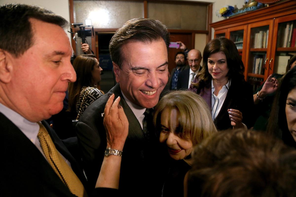 Candidate Alex Díaz de la Portilla celebrates his victory in the runoff election for City of Miami District 1 with his family and friends, including Commissioner Joe Carollo, left, in Miami, on Tuesday, Nov. 19, 2019.