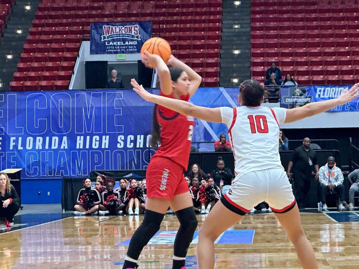 Doral Academy girls basketball guard Stephanie Vega looks for an open teammate while guarded by Colonial’s Carmen Richardson on Friday morning in the Class 7A state semifinals against Orlando Colonial at RP Funding Center.
