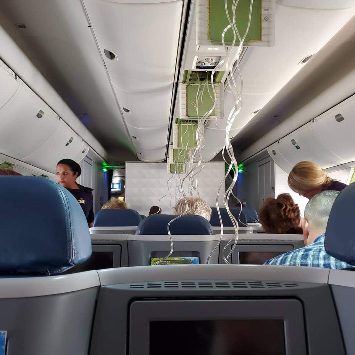 One Twitter user posted photos of the dangling oxygen masks, with flight attendants checking on passengers.