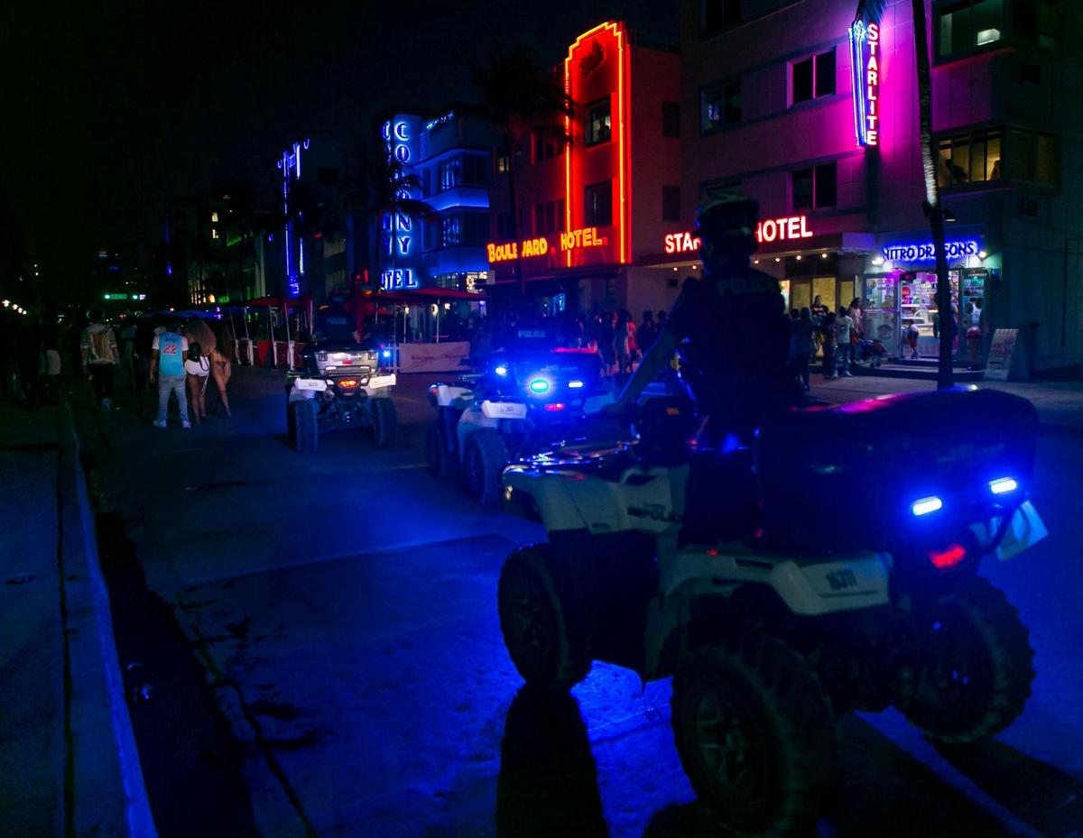 Police enforce an 8 p.m. curfew on Ocean Drive during Spring Break in Miami Beach, Florida on Friday, March 26, 2021.