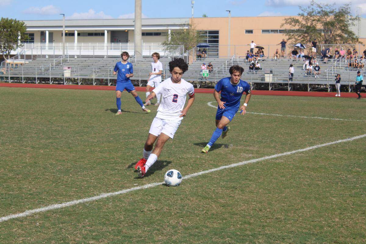 Columbus’ Christian Guadagno (2) tracks down a loose ball as Cypress Bay’s Giancarlo Dostilio gives chase during the Region 4-7A semifinal on Saturday at Cypress Bay High. The host Lightning prevailed 1-0 on Dostilio’s late goal.