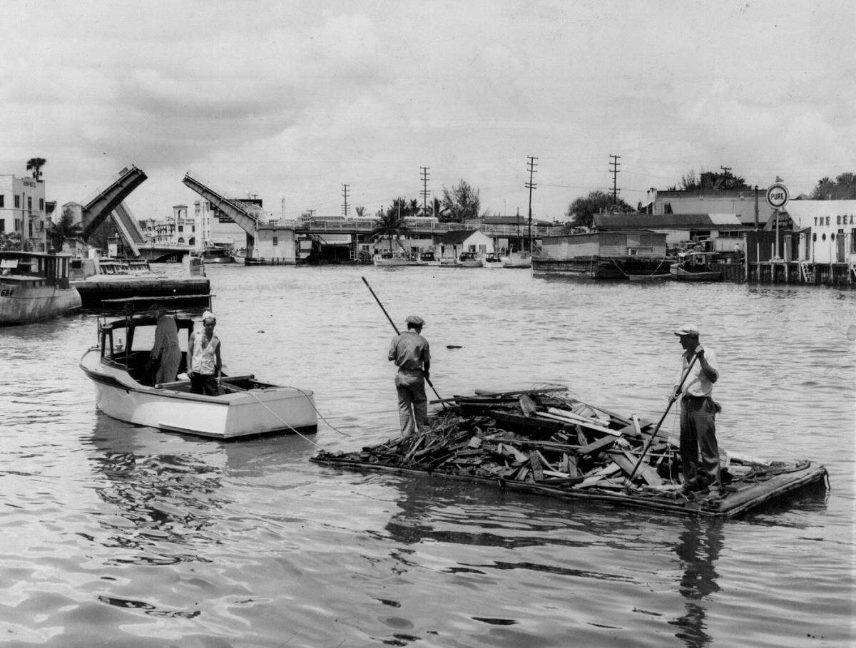 In 1945, cleanup on the Miami River aimed to clear a stream of floating debris that endangers small boats.