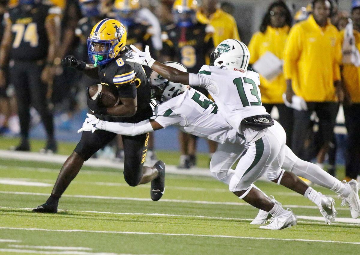 Miami Central Rockets defenders try to stop Northwestern Bulls Elijah Hardy (8) during football game on Friday, October 4, 2024 at Traz Powell Stadium in Miami. Andrew Uloza / for Miami Herald