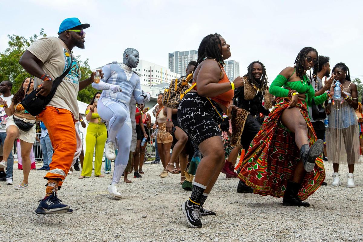 People dance to live music during AFROPUNK music festival at The Urban in the Historic Overtown neighborhood of Miami, Florida, on Saturday, May 21, 2022.
