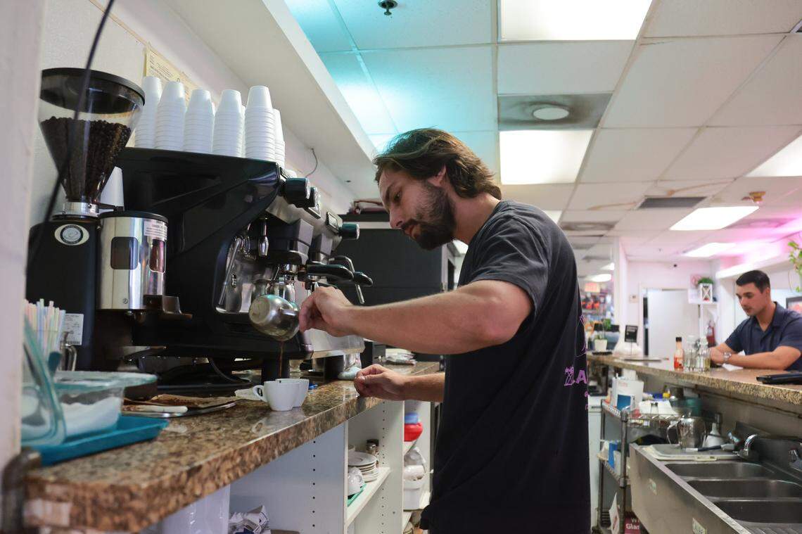 Las Palmas Restaurant owner Mario Ferrari Magalhaes pours Cuban coffee into a cup for a customer sitting at the bar at 209 SE First St., in downtown Miami, Florida, on Thursday, Nov. 6, 2025.