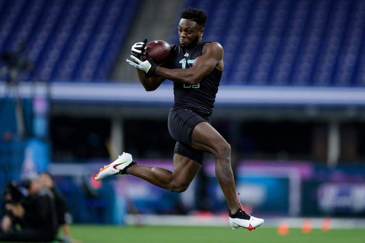 Auburn defensive back Noah Igbinoghene runs a drill at the NFL football scouting combine in Indianapolis.