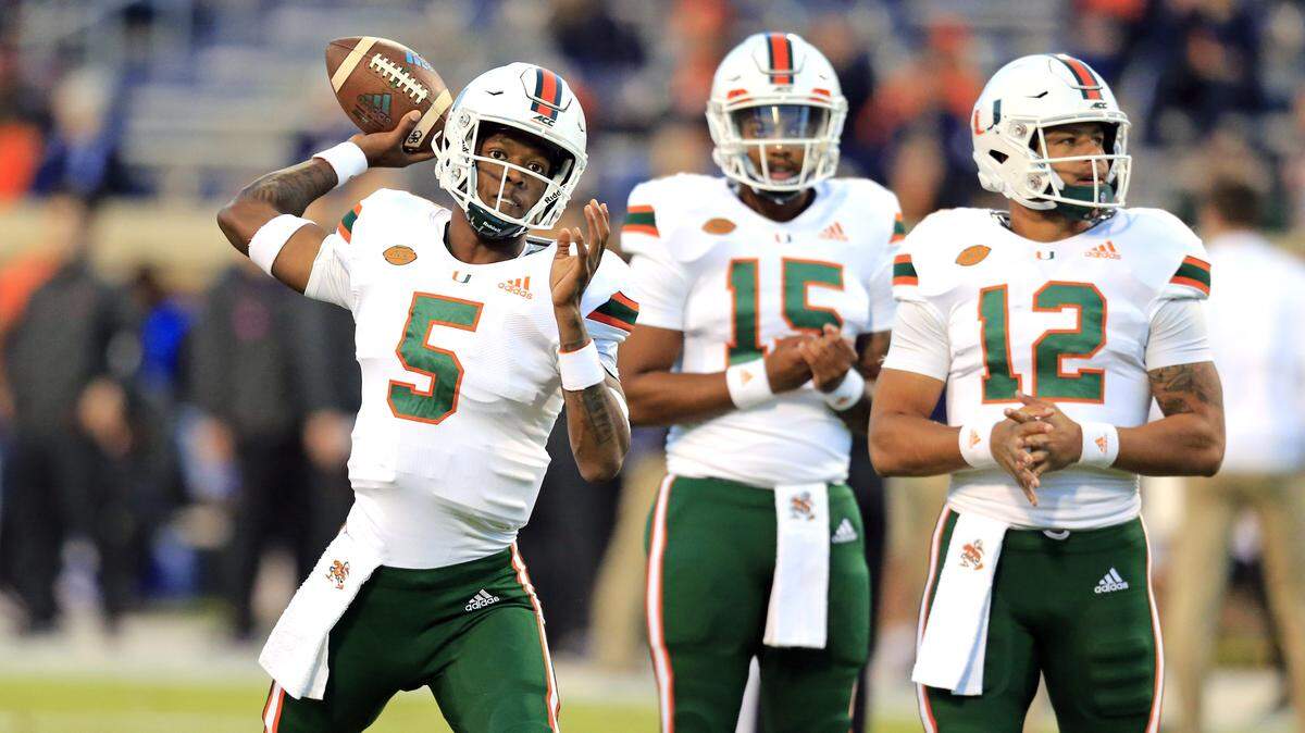 Miami Hurricanes quarterbacks N’Kosi Perry (5), Jarren Williams (15) and Malik Rosier (12) warm up before UM’s game against the Virginia Cavaliers at Scott Stadium in Charlottesville, Virginia on Saturday, October 13, 2018.