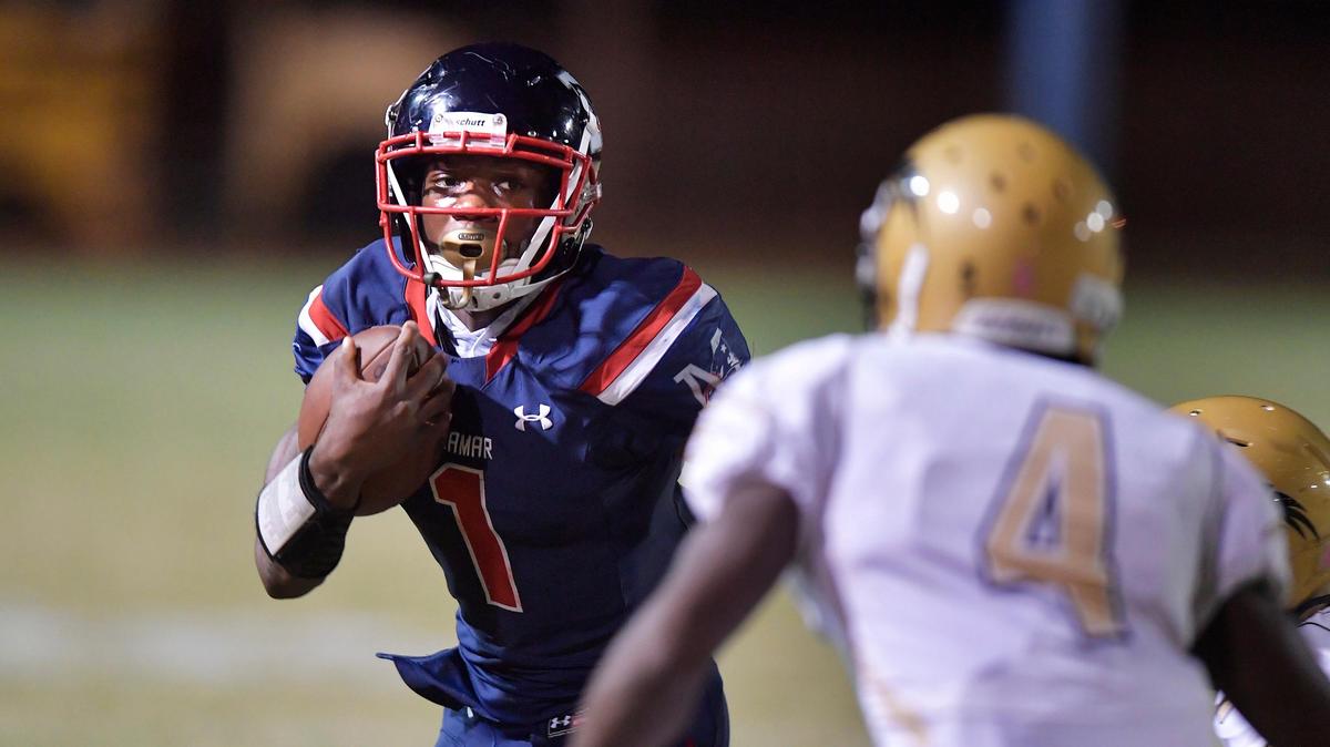 Miramar running back Clifton Miller tries to run past Western’s Lilton Horne during the first half of their game, Friday, October 26, 2018, at Miramar High School