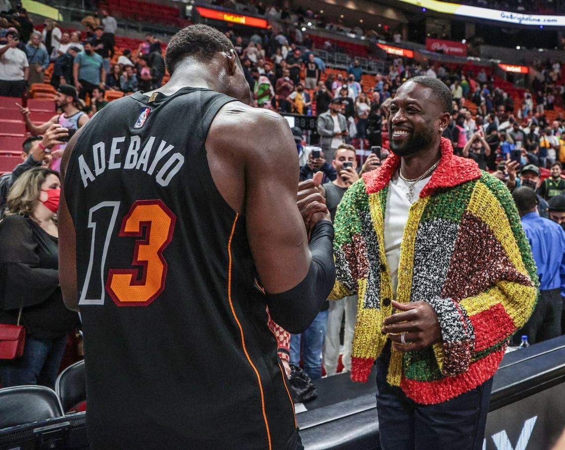 Miami Heat center Bam Adebayo (13) and Dwyane Wade meet up after the Heat defeat the Washington Wizards in Miami on November 18, 2021.