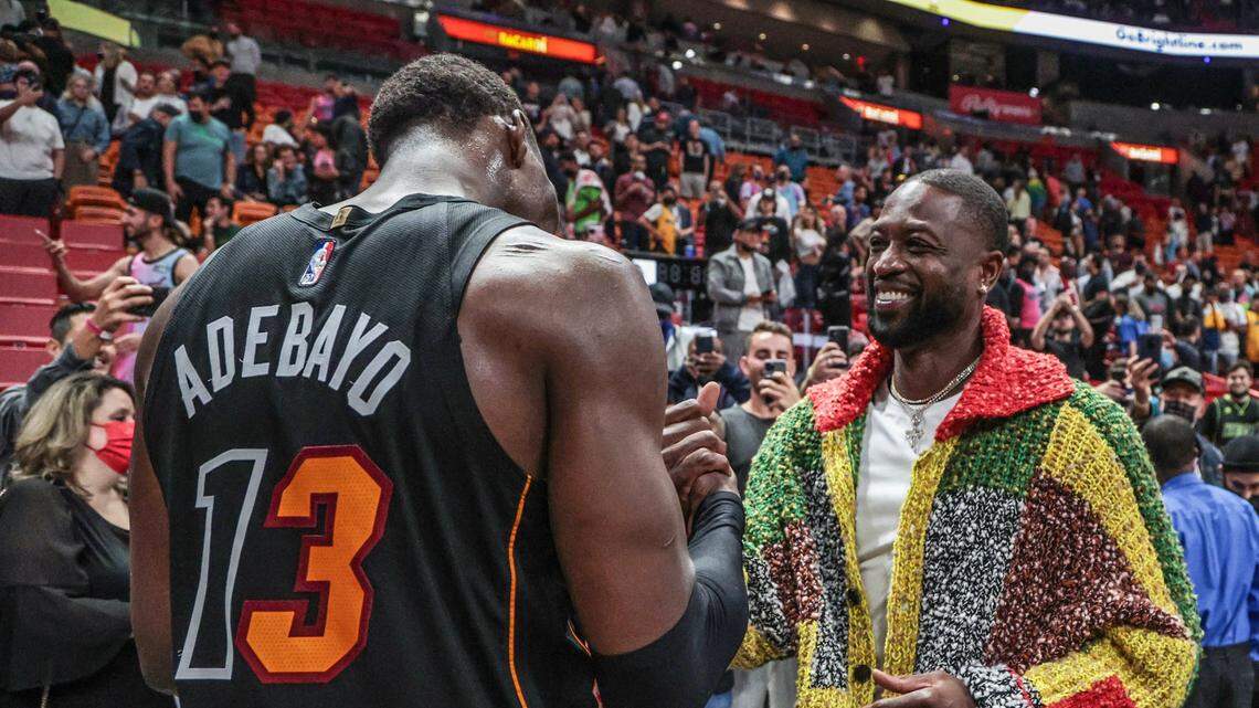 Miami Heat center Bam Adebayo (13) and Dwyane Wade meet up after the Heat defeat the Washington Wizards in Miami on November 18, 2021.