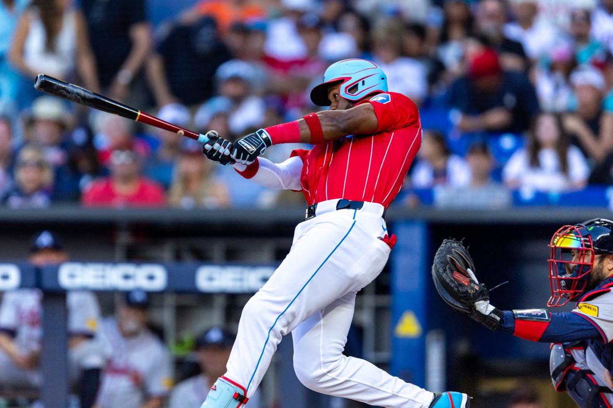 Miami Marlins batter Bryan De La Cruz (14) hits a double for 3 RBIs during the fifth inning of an MLB game at LoanDepot Park in Miami, Florida, on Saturday, April 13, 2024.
