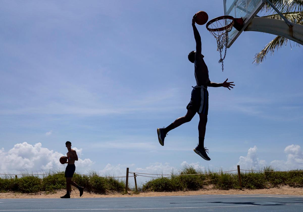 Guerson Valentin, 19, plays basketball at the Central Beach Basketball Courts in Las Olas Beach in Fort Lauderdale, Florida on Saturday, May 30, 2020.