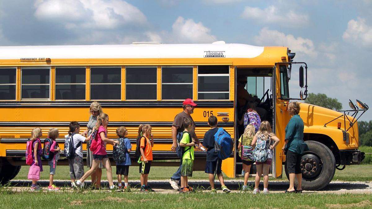 Students board a bus on the first day of school in Bates County, Missouri, on August 14, 2013. Miami R-1 Elementary School has started a four-day school week adding about half an hour to the other days and is embracing technology such as iPads in the classroom. (Tammy Ljungblad/Kasas City Star/MCT)