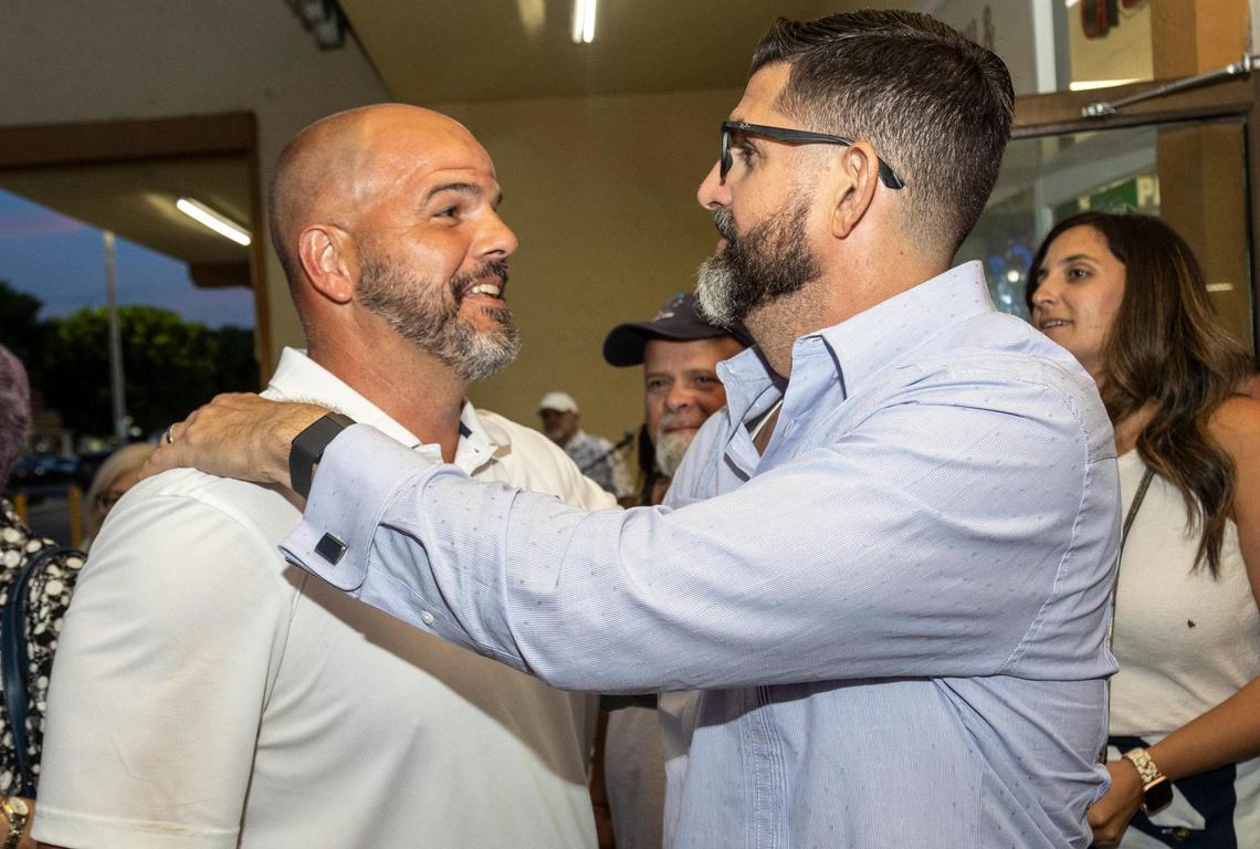 Roberto Alonso, left, is congratulated by Manny Diaz Jr., Florida’s education commissioner, during a party at Paraiso Tropical in Hialeah on Aug. 23, 2022. Alonso, who won the open seat on the Miami-Dade School Board vacated by longtime chair Perla Tabares Hantman, was endorsed by Florida Gov. Ron DeSantis .