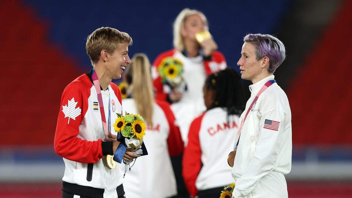 Gold medalist Quinn of Canada’s soccer team speaks with Megan Rapinoe of Team USA after becoming the first openly transgender athlete to win Olympic gold at International Stadium Yokohama on August 6, 2021 in Yokohama, Kanagawa, Japan.