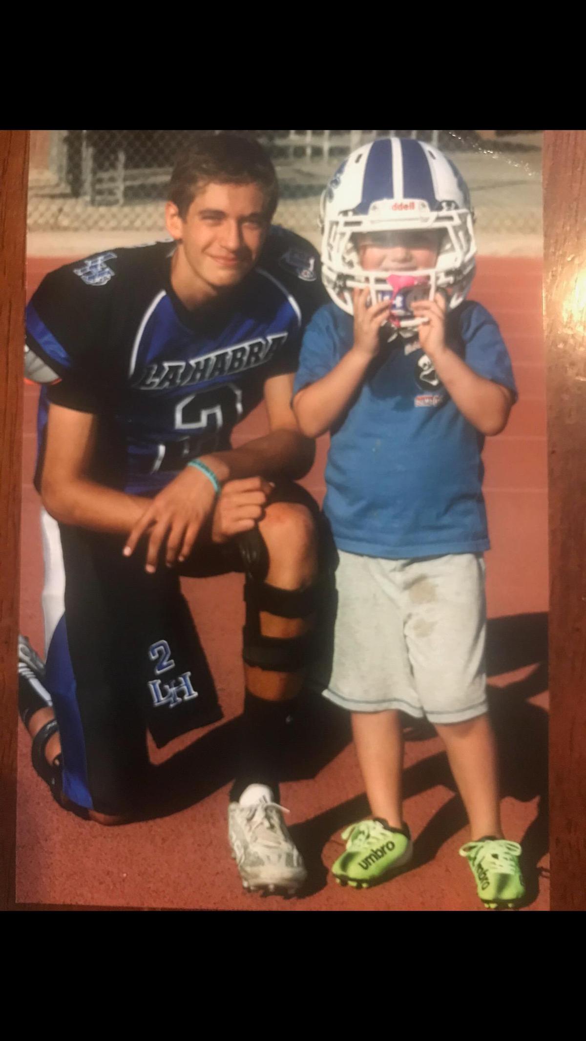 Quarterback Jake Garcia, who signed with the University of Miami in the recruiting class of 2021, is shown at age 13 with his younger cousin Travis.