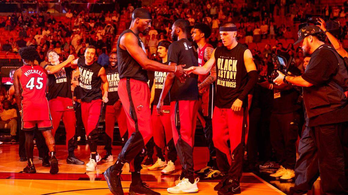 Miami Heat center Bam Adebayo (13) and Miami Heat guard Tyler Herro (14) react during the player introductions before an NBA game on February 26, 2025, in Miami.