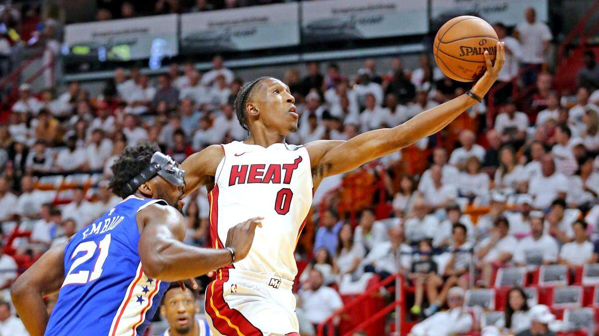 Miami Heat Josh Richardson leaps past Philadelphia 76ers Joel Embiid for a basket in the first quarter of Game 4 of this playoff series. Richardson hopes to play in Game 5 despite a shoulder injury.