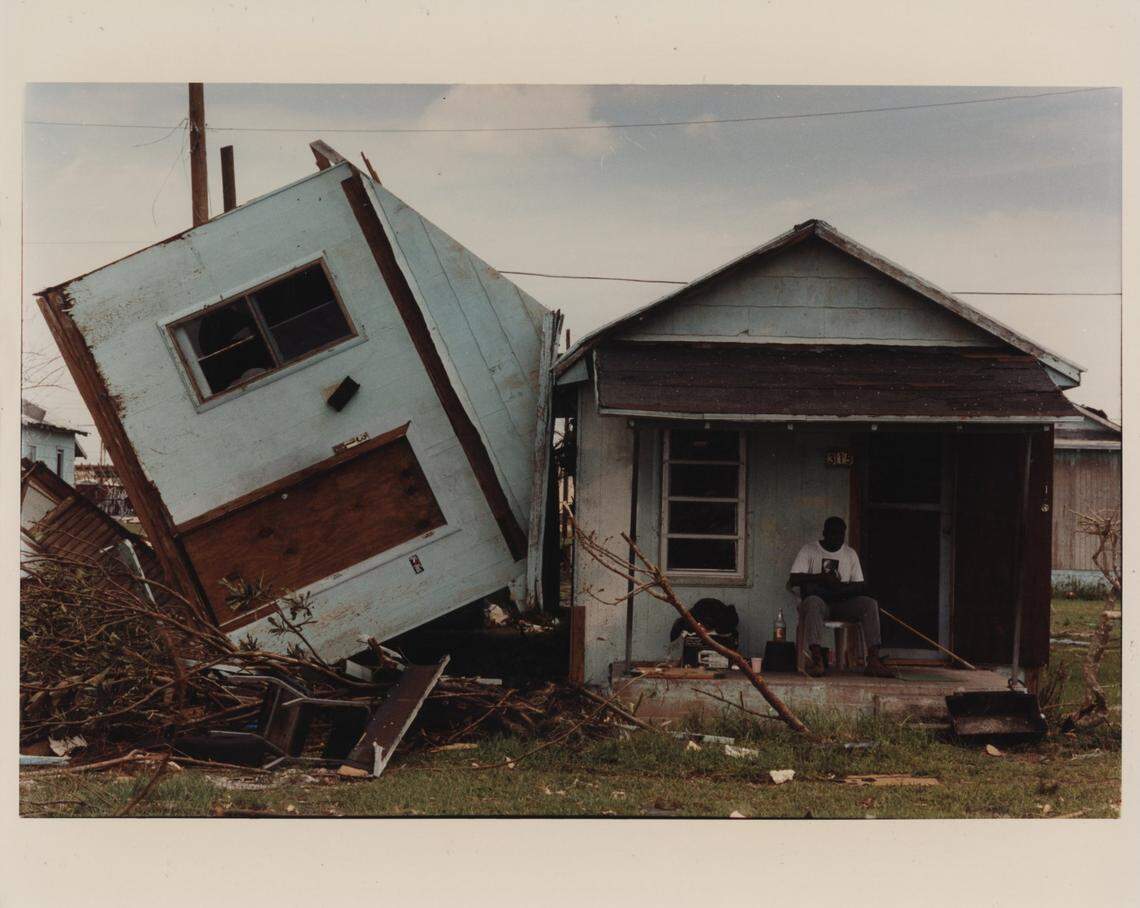 TIPPED, Mark Futch sits listening to his radio on Southwest 6th Avenue in Homestead. The town of 25,000 saw 80 percent of its homes destroyed. What had once been a quiet farm-oriented community on the edges of an urban megalopolis had become a scene of unrelenting ruin.