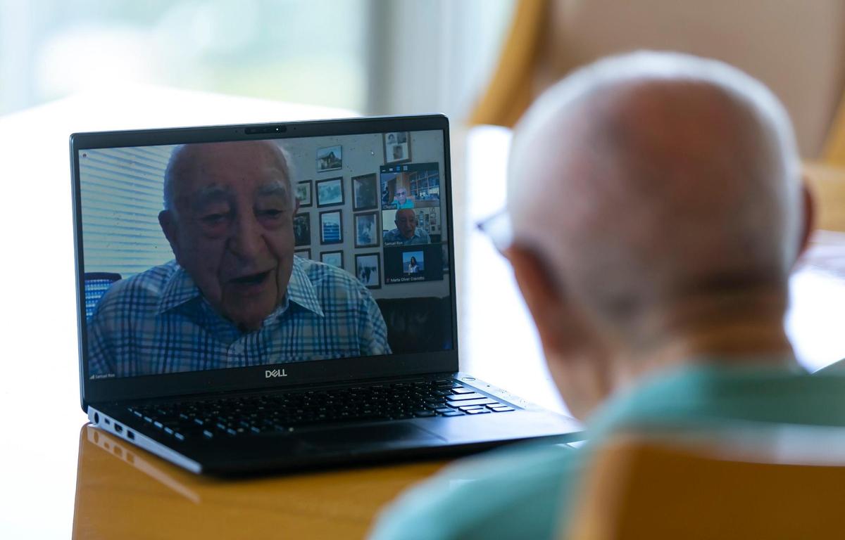 Holocaust survivors Jack Waksal, 97, right, and Sam Ron, 97, talk over a Zoom call at Waksal’s apartment in Bal Harbour, Florida on Tuesday, April 26, 2022. Both men recently reunited at the U.S. Holocaust Memorial Museum’s annual dinner in March in Boca Raton after 79 years. The two were in the same work camp in occupied Poland.