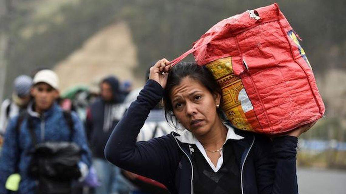 A Venezuelan woman heads to Peru, walking along the Panamerican Highway in Tulcan, Ecuador, after crossing over from Colombia.