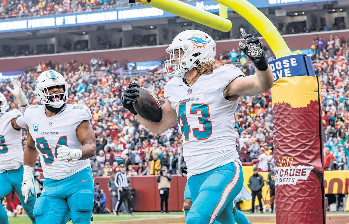 Miami Dolphins linebacker Andrew Van Ginkel (43) celebrates his touchdown on an interception against the Washington Commanders in the first quarter at FedEx Field in Landover, Maryland on Sunday, December 3, 2023.
