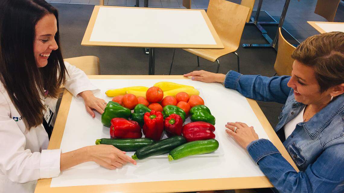 Amanda Amigo, left, a registered dietitian at Cleveland Clinic Weston, goes over healthy food choices with Nancy Shapiro, who was diagnosed with breast cancer three years ago. Eating healthy and hydrating are critical when undergoing cancer treatment, when your body’s immune system often is weakened.