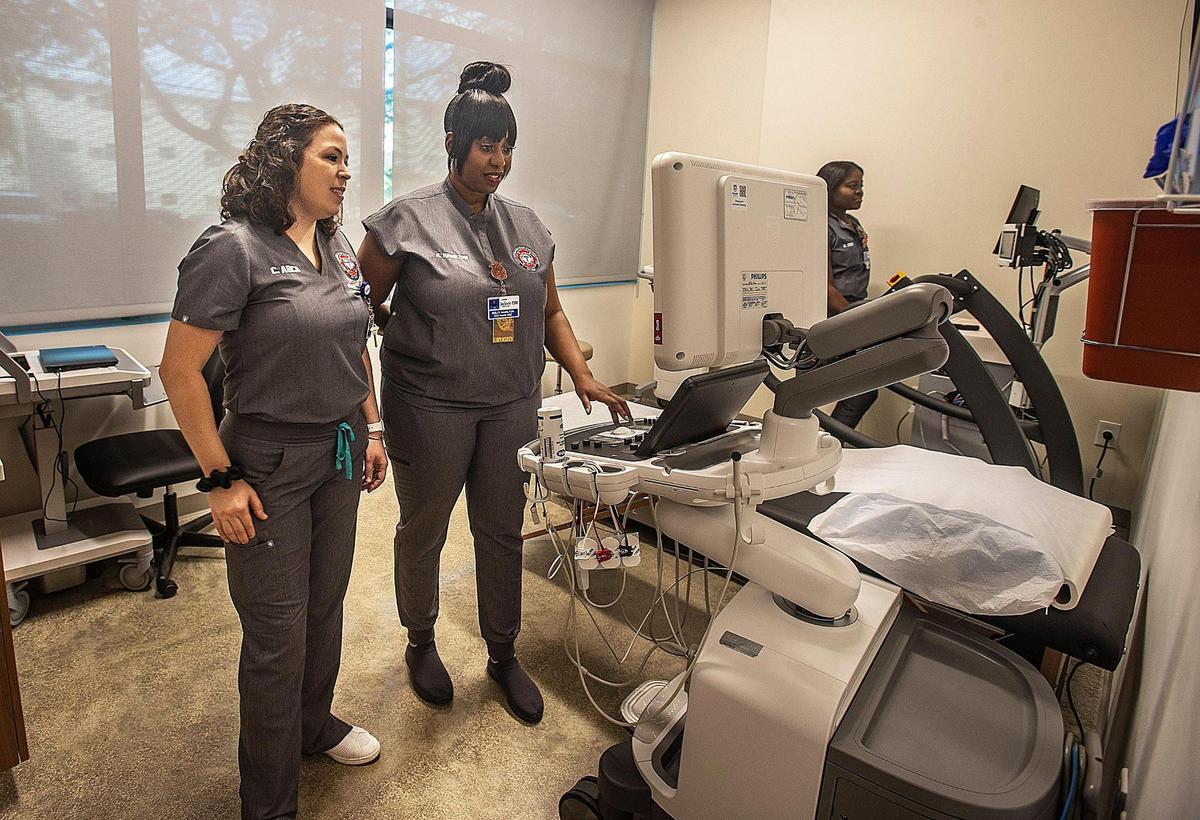 Medical staff members Camille Arca, left, and Nolty Hamilton look at the cardiac test room Thursday, March 2, at the new Miami Firefighters Health & Wellness Center, located near loanDepot park in Little Havana. The center, created by Miami Fire Rescue and Jackson Health System, will offer free physicals and health screenings to city firefighters.