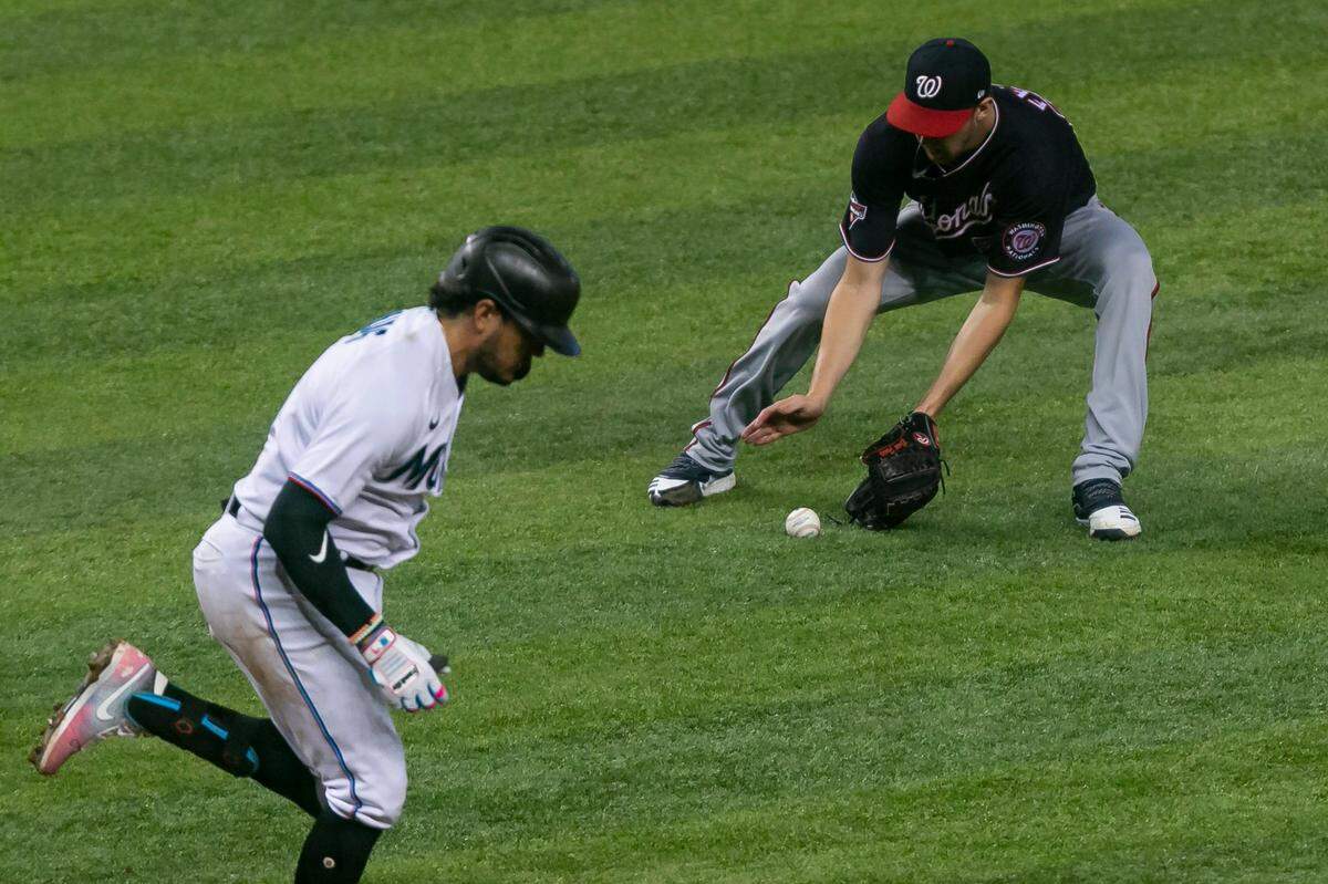 Washington Nationals starting pitcher Erick Fedde (23) catches a ground ball from Miami Marlins shortstop Miguel Rojas (19) in the second inning of a Major League Baseball game during the first game of a doubleheader at Marlins Park in Miami, Florida on Friday, September 18, 2020.