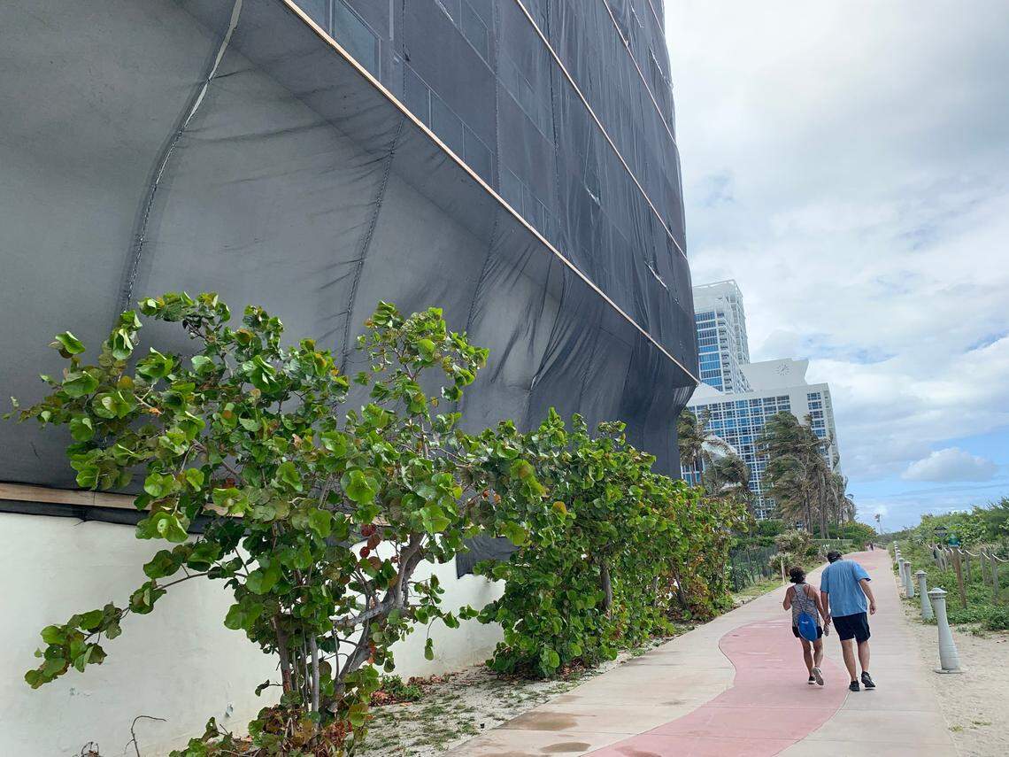 Black mesh covers the ocean-facing side of the Deauville Beach Resort in Miami Beach on March 10, 2021. The hotel, famous for hosting the Beatles in 1964 when the band performed on “The Ed Sullivan Show,” has been closed since 2017. The city of Miami Beach sued the hotel owners for failing to maintain the historic building.