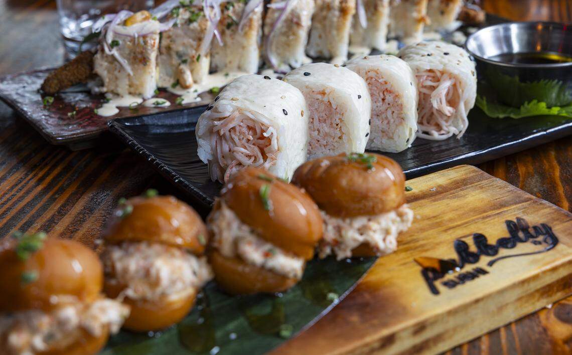 From top to bottom: An Acevichado Roll, a Butter Krab Roll, and Lobster & Crab Donuts are prepared at Pubbelly Sushi on Thursday, Sept. 18, 2025, in Miami Beach, Fla. The restaurant is celebrating its 15th anniversary.