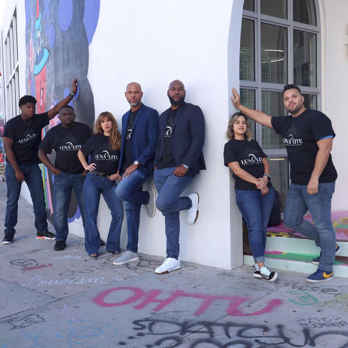 LunaLite cofounders Adrian Allen and Arturo Lorde operate a newly launched drone show business from Wynwood. They stand with their team, from left, Lawrence Wright, Granville Bailey, Lindsey Koggan, Allen, Lorde, Stephanie Cruz, and Brandon Braswell.