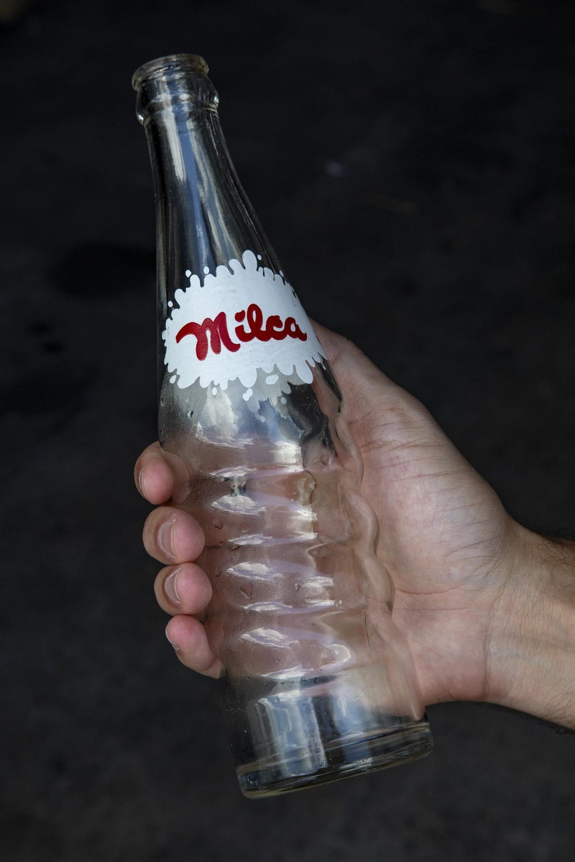 Milca Bottling Co. President & CEO, Javier Cuadra holds a vintage bottle of Milca soft drink.