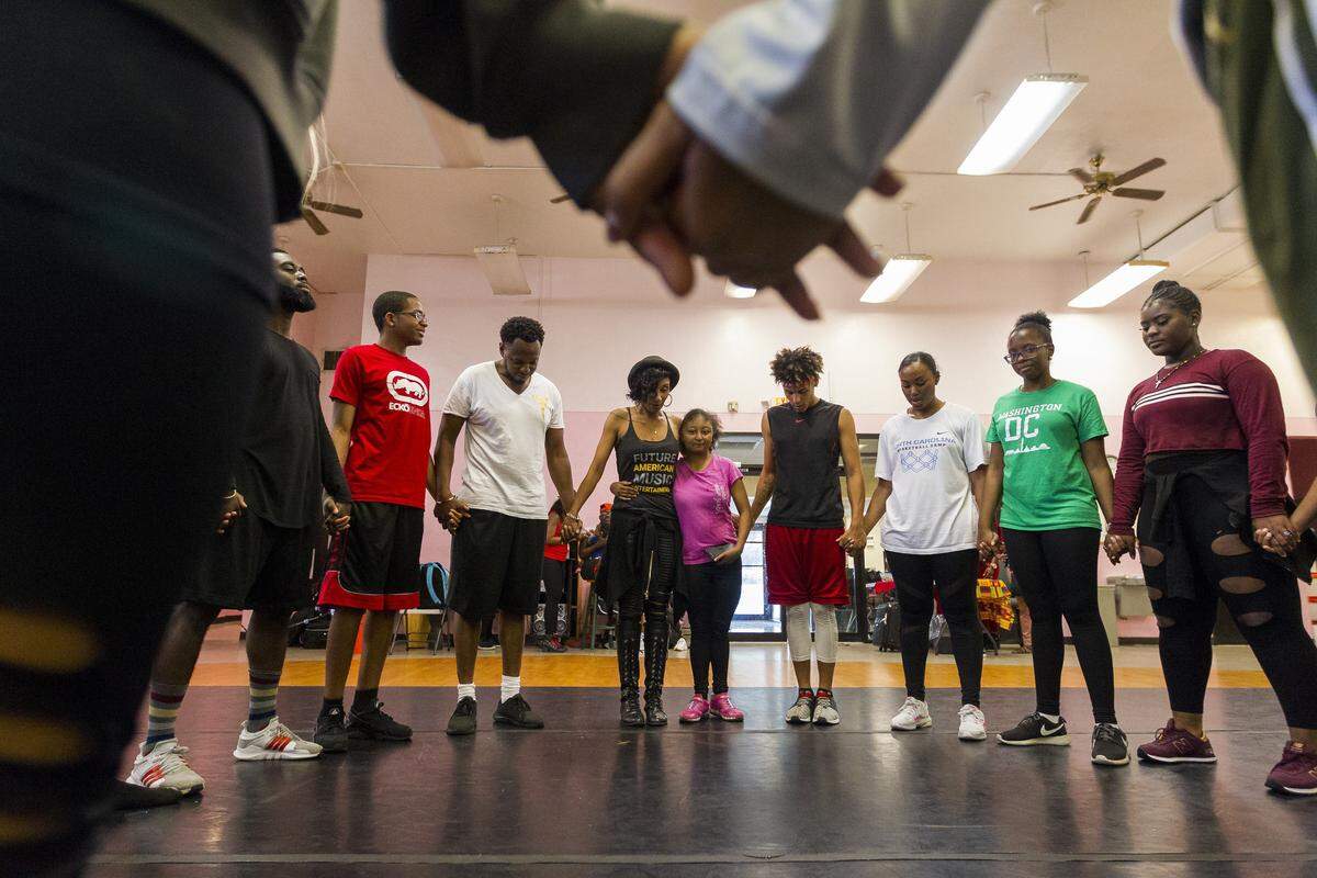 Preparing for the show: Entourage finalists talk in a group after their rehearsal session at the African Heritage Cultural Arts Center in Liberty City. Their finale show is April 28.