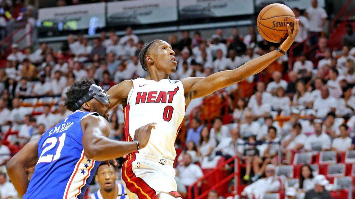 The Miami Heat's Josh Richardson leaps past Philadelphia 76ers' Joel Embiid during Game 4 of the NBA Playoffs at the AmericaneAirlines Arena in Miami,  April 21, 2018.