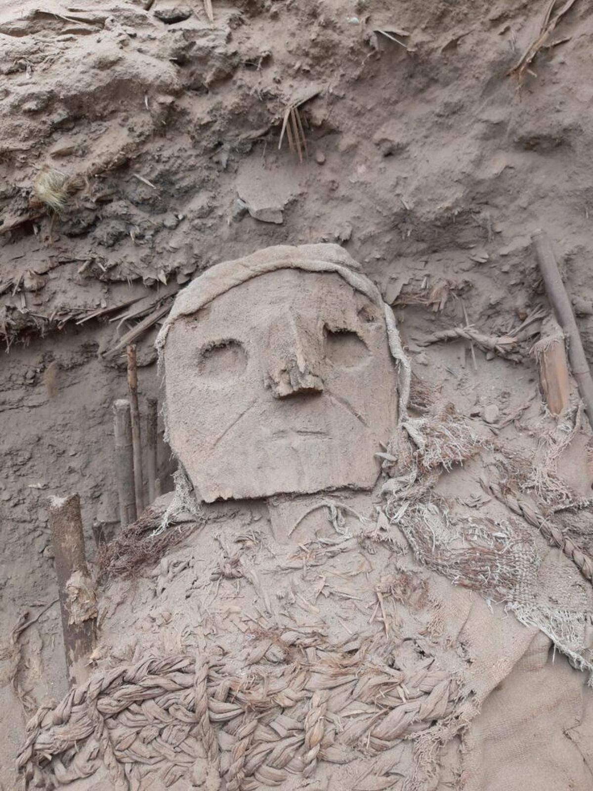 Some of the burials wore wooden masks on “false-heads.”