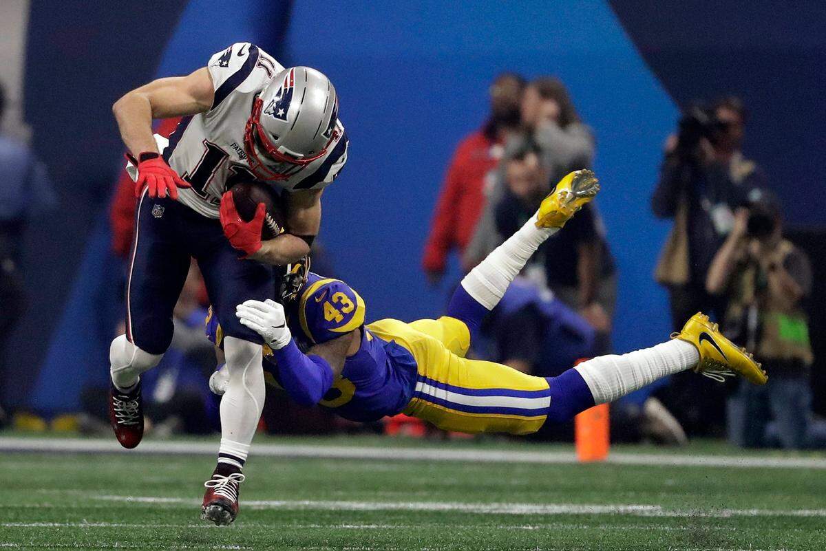 New England Patriots’ Julian Edelman (11) breaks a tackle by Los Angeles Rams’ John Johnson III (43), during the second half of the NFL Super Bowl 53 football game Sunday, Feb. 3, 2019, in Atlanta. (AP Photo/Jeff Roberson)