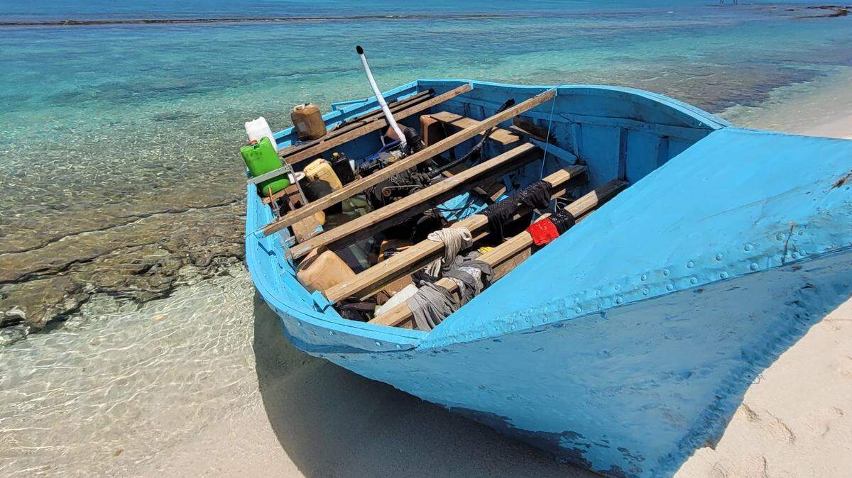 A blue homemade migrant boat is beached on an island in the Dry Tortugas National Park Saturday, Sept. 9, 2023.