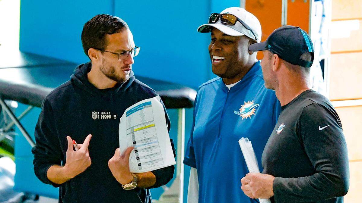 Miami Dolphins coach Mike McDaniel speaks with general manager Chris Grier, at center, and special teams coordinator Danny Crossman, at right, during practice at the Baptist Health Training Complex in Miami Gardens on Wednesday, October 11, 2023.