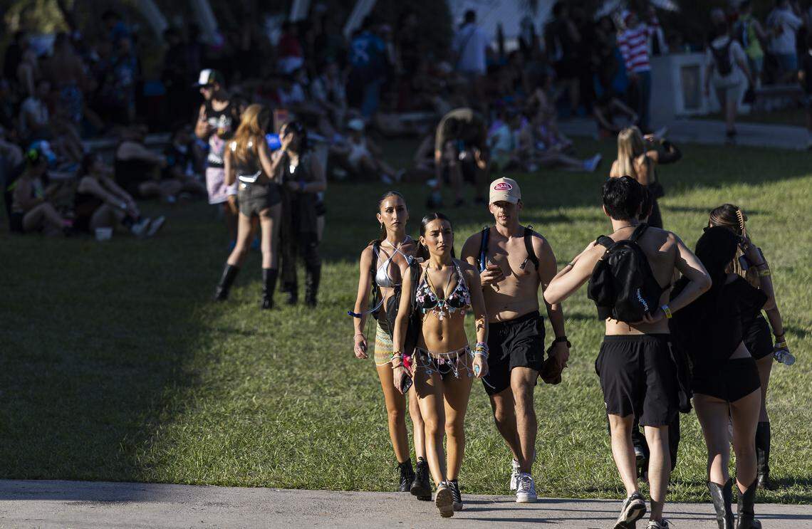 People walk through Bayfront Park as they attend Ultra Music Festival’s 26th anniversary on Saturday, March 28, 2026, in downtown Miami, Fla.