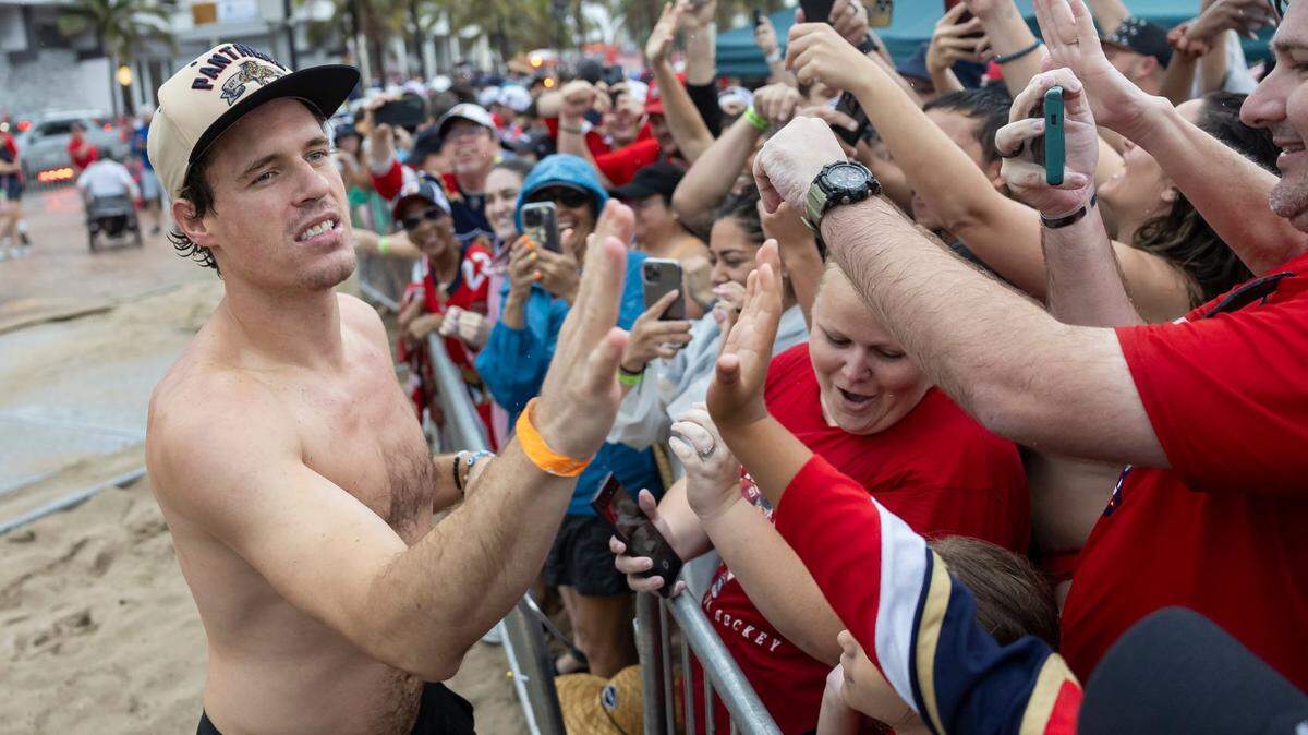 Florida Panthers center Nick Cousins (21) high-fives fans during the Stanley Cup victory parade at the Fort Lauderdale Beach Park off A1A on Sunday, June 30, 2024, in Fort Lauderdale, Fla. The parade was held to celebrate the Florida Panthers after they defeated the Edmonton Oilers in Game 7 of the Stanley Cup Final.