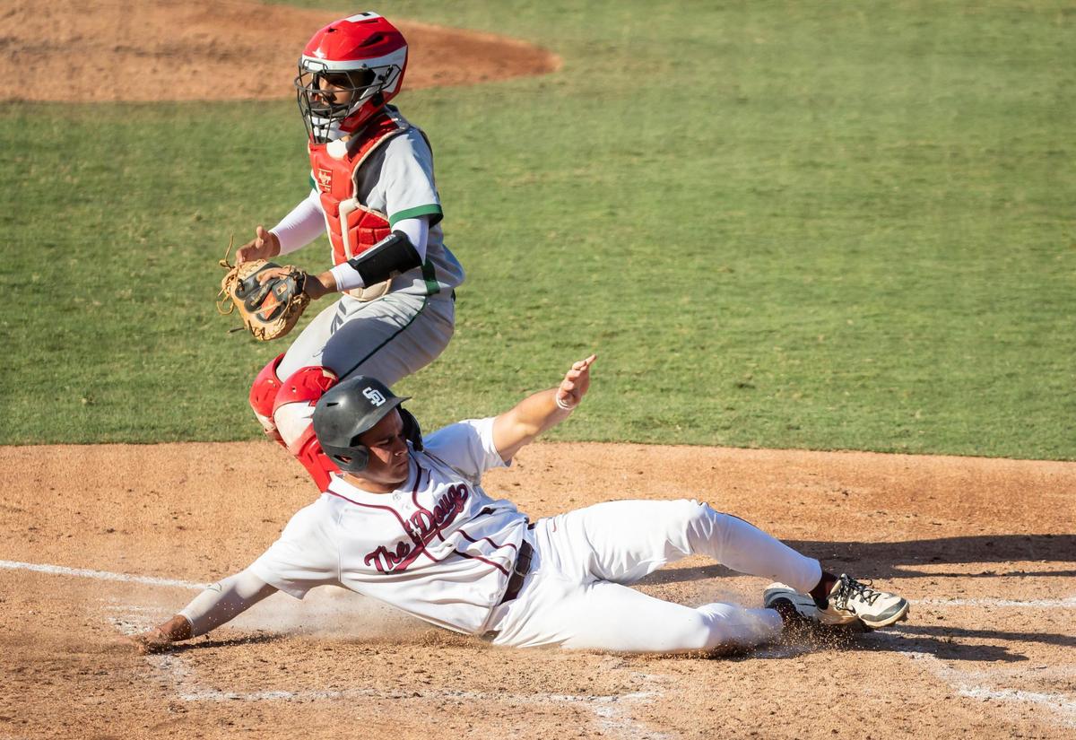 Stoneman Douglas Eagles center fielder Lorenzo Laurel (6) slides to score a run against the Jupiter Warriors in the third inning of his Class 7A state baseball championship game against the Jupiter Warriors at Hammond Stadium on Saturday, May 17, 2025, in Fort Myers, Fla.