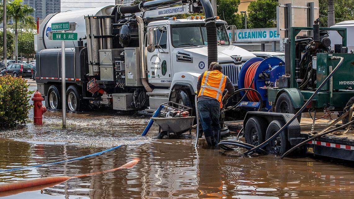 Workers with the Environmental Land Development Company pump out water at the intersection of Broward Boulevard and NW 8th Ave. in Fort Lauderdale, still flooded after heavy rain in Broward County for the last two days, on Thursday April 13, 2023.